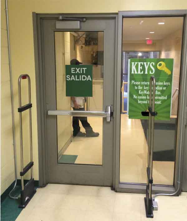 Woman selects a key from a Key Box System